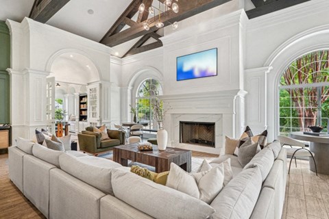a living room with a large couch and a fireplace